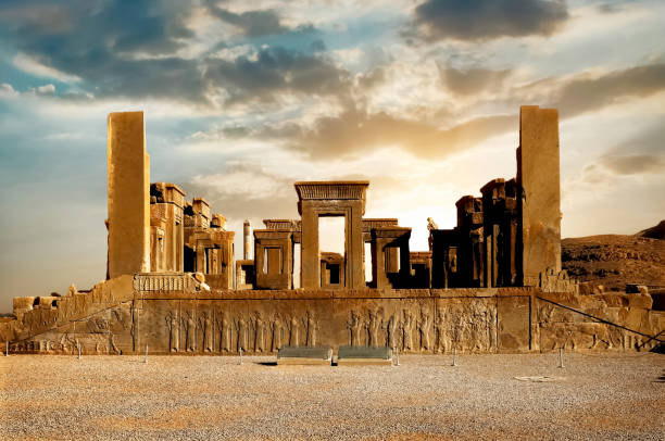 Sunrise in Persepolis, capital of the ancient Achaemenid kingdom. Ancient columns. Sight of Iran. Ancient Persia. Beautiful sunrise background. Sunrise in Persepolis, capital of the ancient Achaemenid kingdom. Ancient columns. Sight of Iran. Ancient Persia. Beautiful sunrise background. persian empire stock pictures, royalty-free photos & images