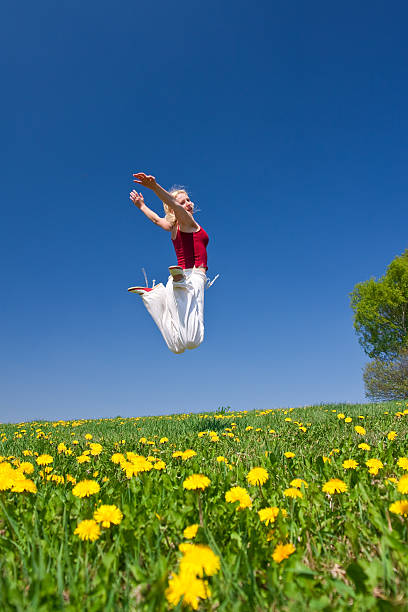 istock young woman in red outfit having fun on meadow 97931792