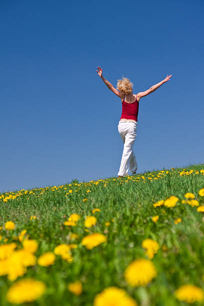 istock young woman in red outfit having fun on meadow 97931799