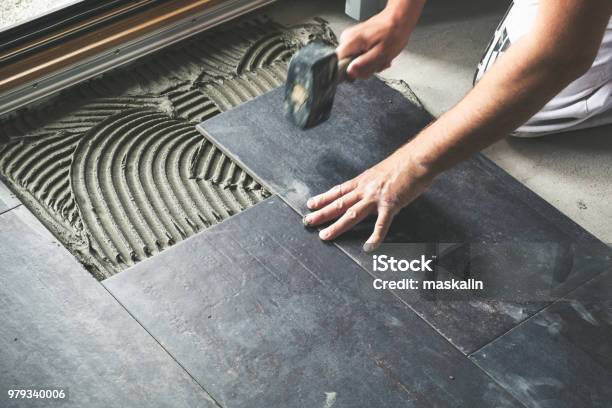 Worker Placing Ceramic Floor Tiles Stock Photo - Download Image Now - Tile, Tiled Floor, Flooring
