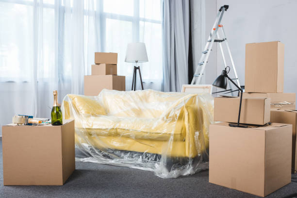 istock empty living room with couch and stacks of boxes during relocation 979344112