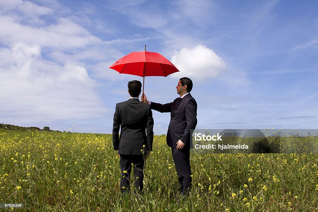 The insurance agent protection The insurance agent in the field, giving you the best protection everywhere  Umbrella Stock Photo