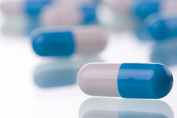 istock Blue and white pills on a pharmacy counter 97935689