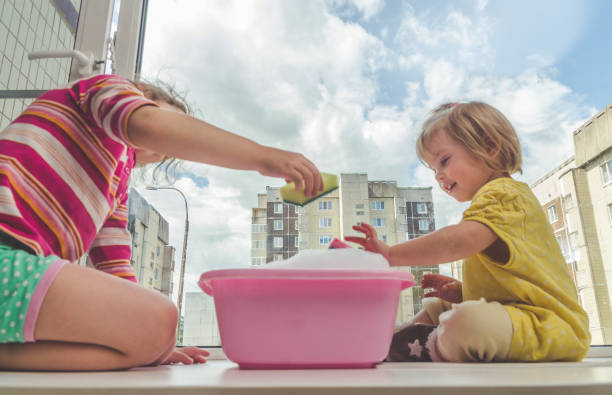 istock child on the windowsill washes the window 979357662