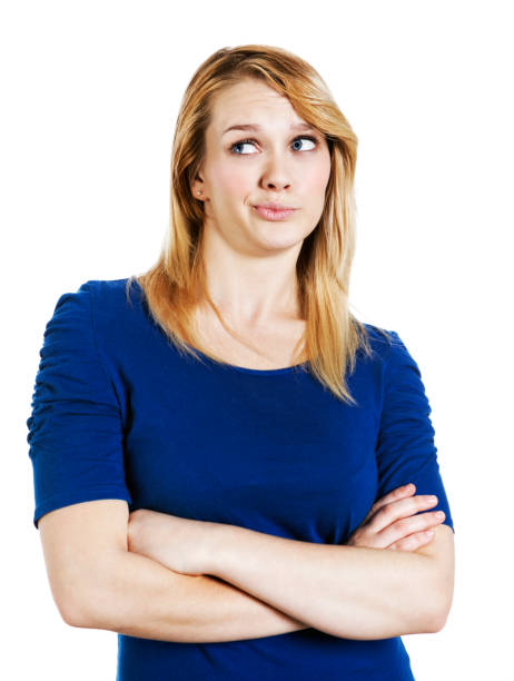 You've got to be kidding! Pretty blonde looks disbelieving. A lovely young blonde woman stands with folded arms rolling her eyes and looking cynical and disbelieving. rolling eyes stock pictures, royalty-free photos & images