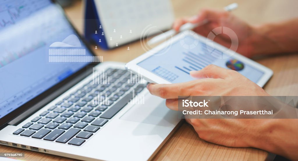 Close up business man hand hold tablet for thinking about stock market graph trading with statistic chart infographic concept Portfolio Stock Photo