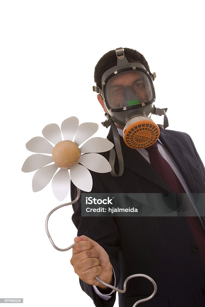 Nature future a businessman with a gas mask holding a flower from the future (selective focus) Adult Stock Photo