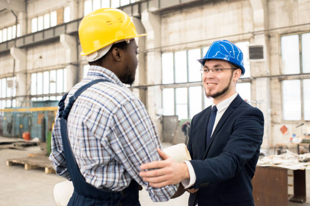 istock Cheerful businessman collaborating with construction manager 979414448