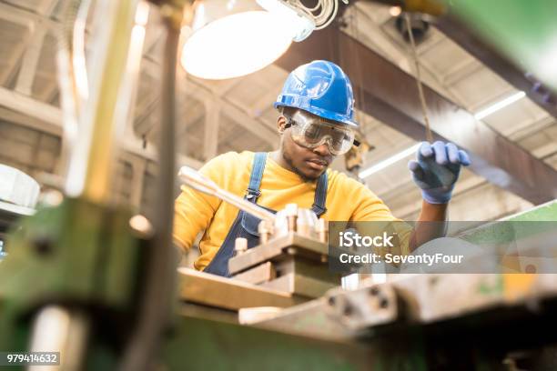 Serious Worker Repairing Manufacturing Machine Stock Photo - Download Image Now - Occupation, Manufacturing, Metal Worker