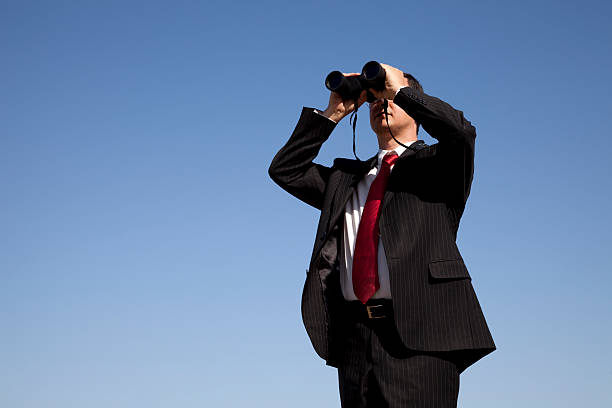 istock A businessman looking through a pair of binoculars  97941525