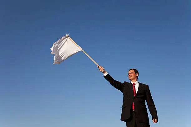 businessman asking for surrendering with a white flag
