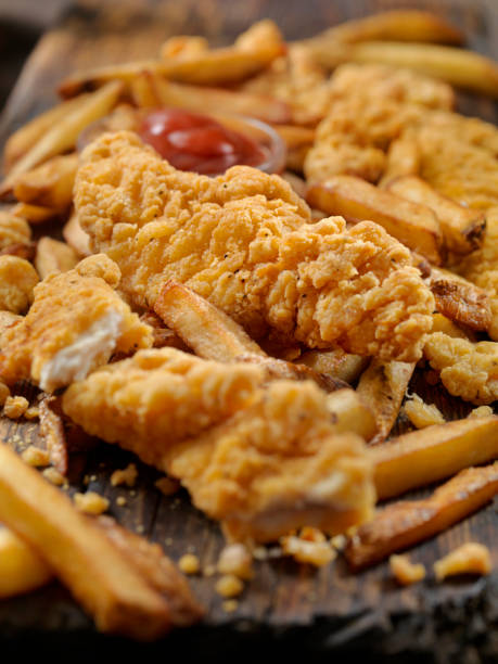 istock Crispy Chicken Strips with Home Cut Fries 979421462