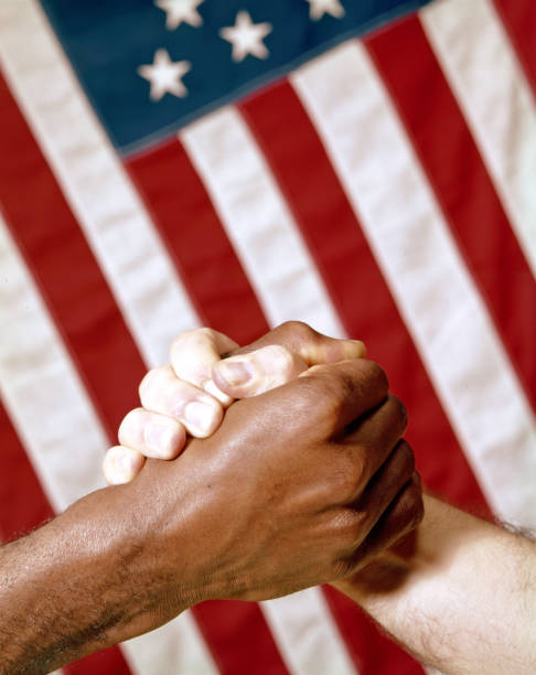 istock black and white hand clasp with american flag 979432604