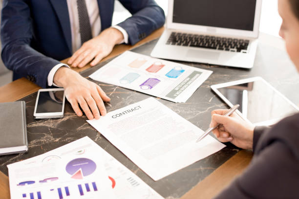 istock Woman signing contract with financial advisor 979438482