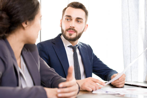 istock Serious businessman viewing documents with colleague 979438548