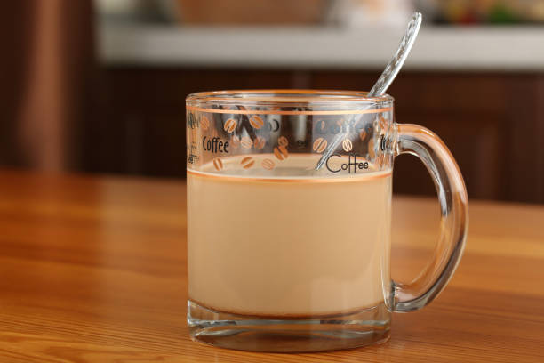 istock Single transparent glass cup with coffee and milk 979447552