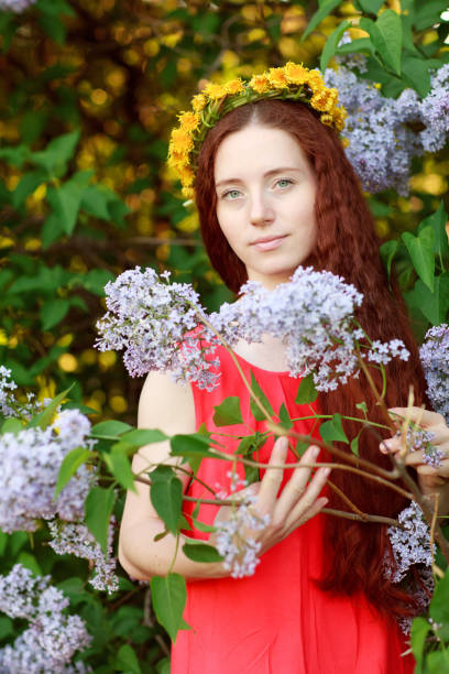 istock Beautiful woman and blooming lilac 979449280