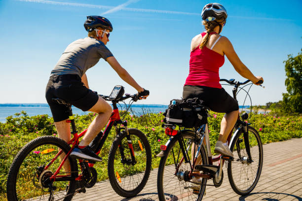istock Healthy lifestyle - people riding bicycles at seaside 979451456