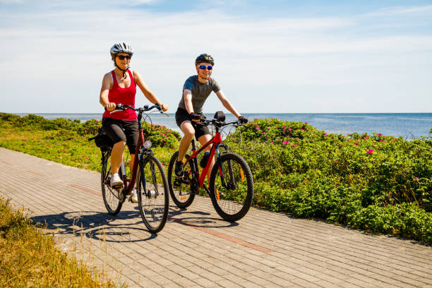 istock Healthy lifestyle - people riding bicycles at seaside 979452072