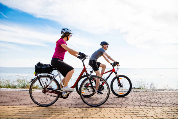 istock Healthy lifestyle - people riding bicycles at seaside 979452190