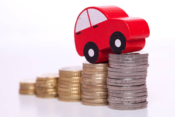 istock A car on top of stack coins on a white background 97945802