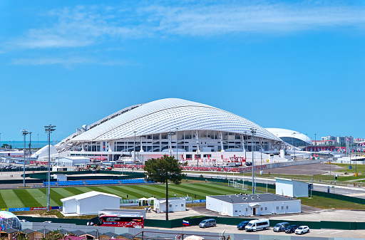 Fisht football stadium arena in Sochi, Russia, 07 July 2017, before World Championship 2018, panoramic horizontal photo. This is one of the largest and the most famous stadiums on the Black Sea coast nicely illuminated either by natural sun or artificial light tonight.