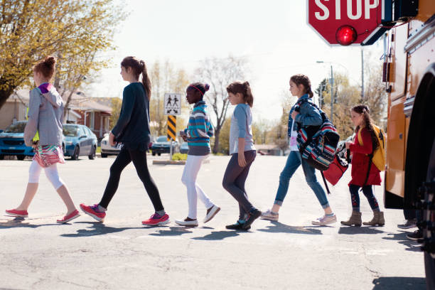istock Multi-Ethnic Group of elementary school kids getting out a school bus at school's out. 979465274