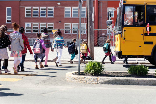 istock Multi-Ethnic Group of elementary school kids getting in a school bus at school's out. 979465816
