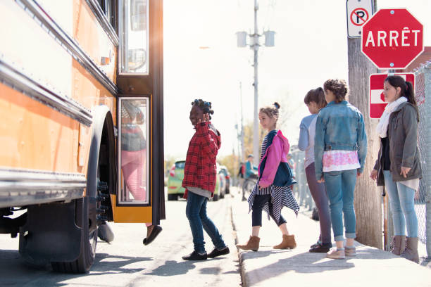 istock Multi-Ethnic Group of elementary school kids getting in a school bus at school's out. 979468626