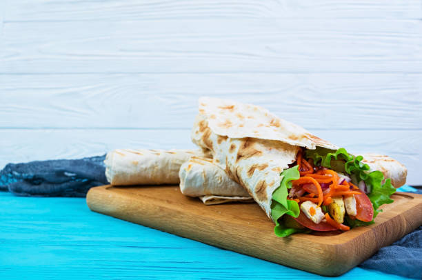 istock Delicious shawarma sandwich on wooden background 979474350