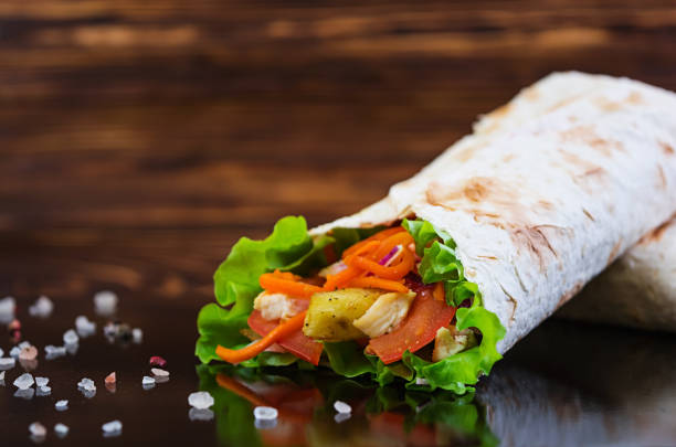 istock Delicious shawarma sandwich on wooden background 979474396