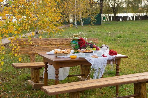 he samovar on the dacha table with pastries and fruits