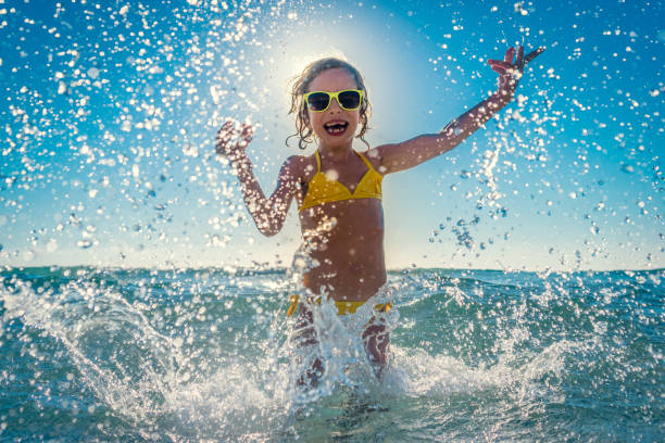 istock Happy child playing in the sea 979483342