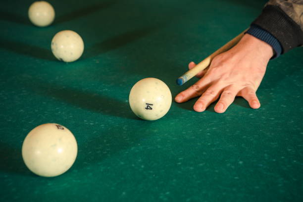 Hand with a cue on the billiard table Hand with a cue on the billiard table best snooker free bet stock pictures, royalty-free photos & images