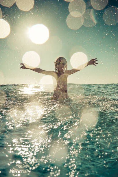 istock Happy child playing in the sea 979483468