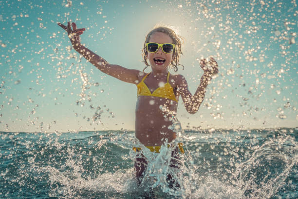 istock Happy child playing in the sea 979483544
