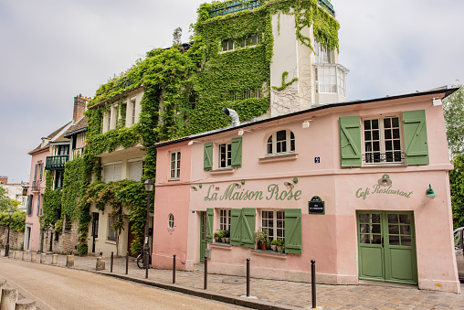 Paris / France - May 16, 2018:  View of the famous restaurant, La Maison Rose, in Montmartre on the famous street, Rue de l'Abreuvoir, known for its charming and historic architecture.