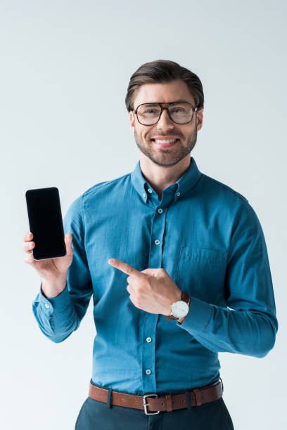 istock happy young man holding smartphone and pointing at blank screen isolated on white 979488540