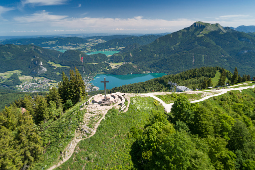 Unique aerial panoramic View of the famous Zwölferhorn Summit Cross with Wolfgangsee and Mondsee, Austrian Alps, Sankt Gilgen, Austria. You can even see the beautiful Schafberg Mountain in back. Converted from RAW.