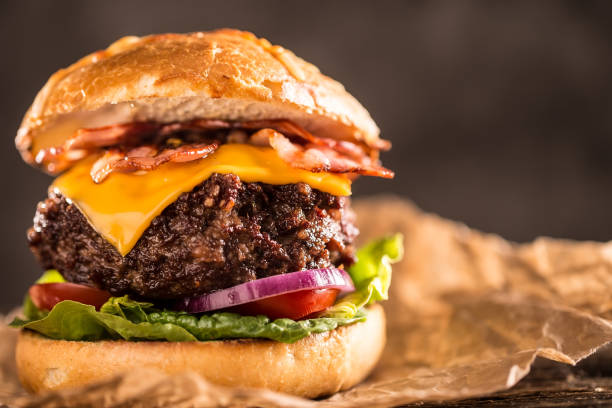 istock Close-up home made beef burger on wooden table. 979488938