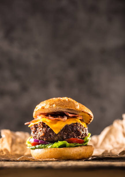 istock Close-up home made beef burger on wooden table. 979488964