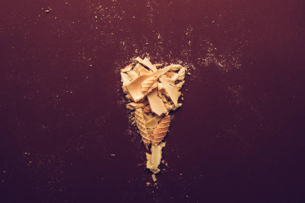 istock Crushed ice cream cone on dark brown background 979491496