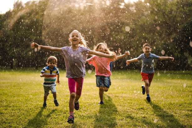istock Happy children enjoying on the rain 979493076