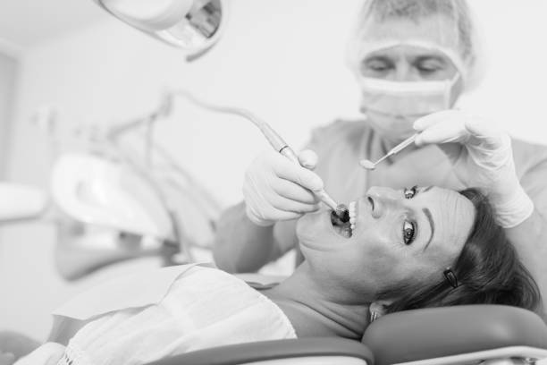 istock dentist professional filling teeth 979498096