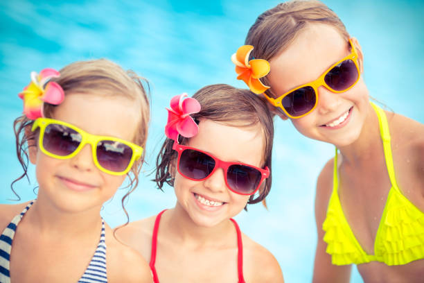 istock Happy children in the swimming pool 979498920