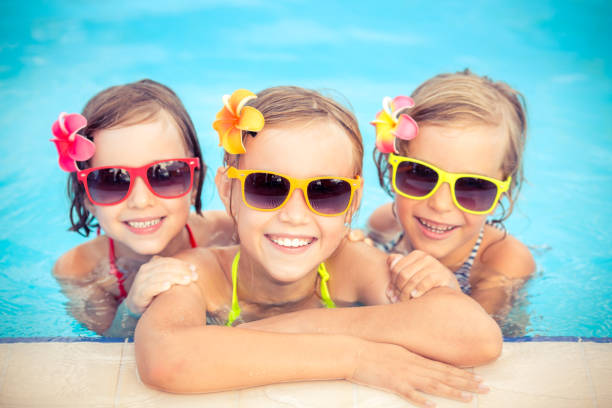 istock Happy children in the swimming pool 979499018