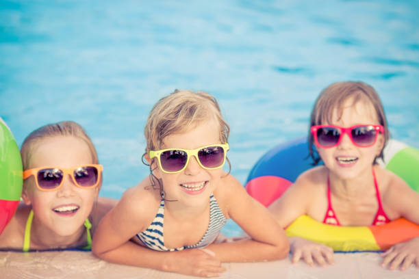 istock Happy children in the swimming pool 979499062