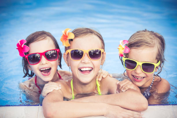 istock Happy children in the swimming pool 979499104