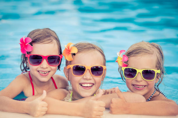 istock Happy children in the swimming pool 979499120
