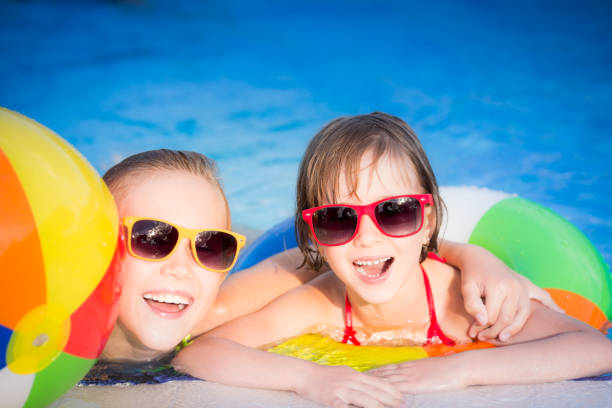istock Happy children in the swimming pool 979499158